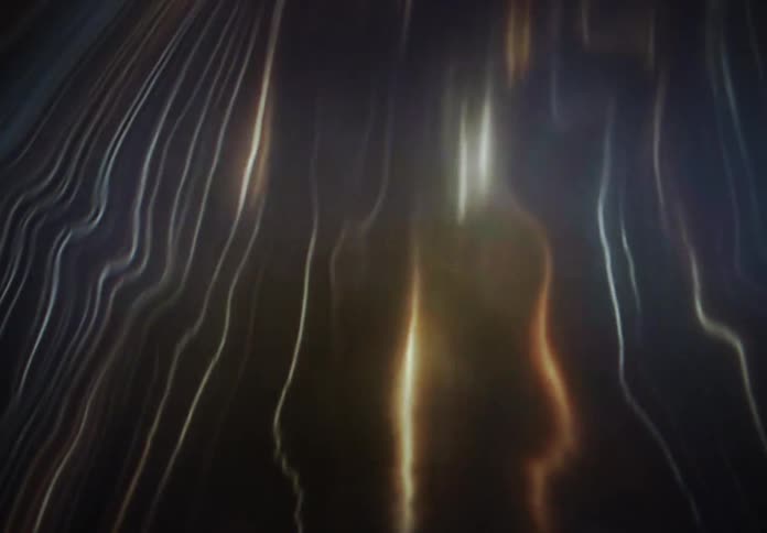 Ethereal light streaks and waves create a mesmerizing abstract background