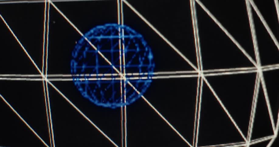 Vintage computer-generated wireframe spheres float and rotate in a dark, digital space