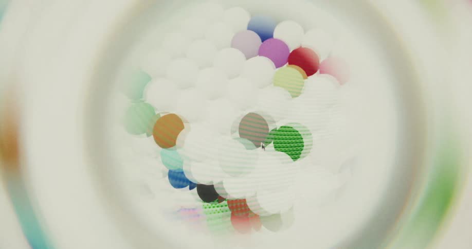 A computer cursor interacts with a rotating 3D grid of colorful and textured spheres in an abstract animation