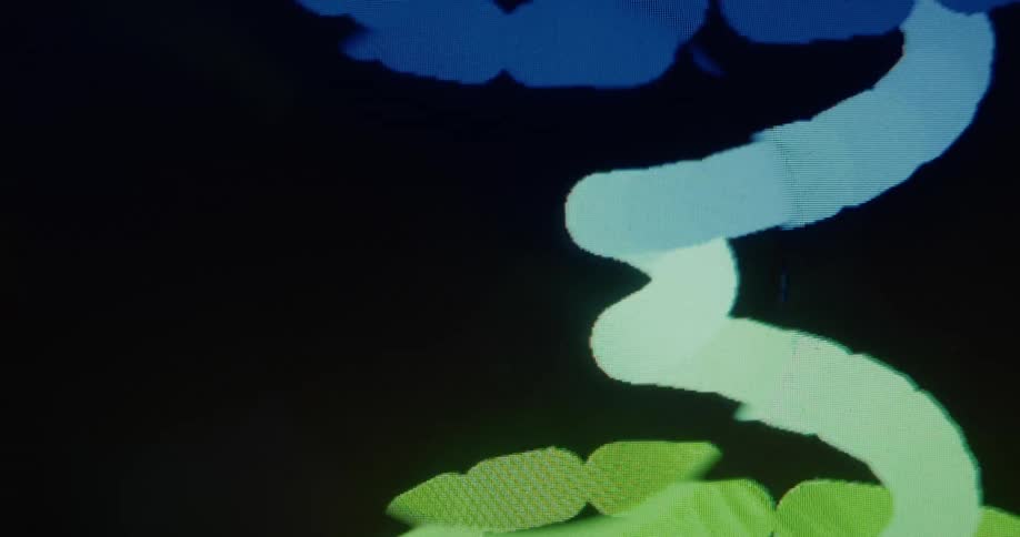 A close-up view of a digital screen showing an abstract art creation with colorful, pixelated shapes and lines moving against a black background