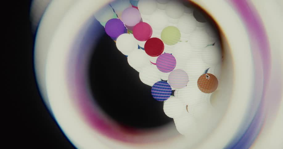 Macro view of a user interacting with a rotating digital structure composed of colorful spheres, viewed through a distorted lens