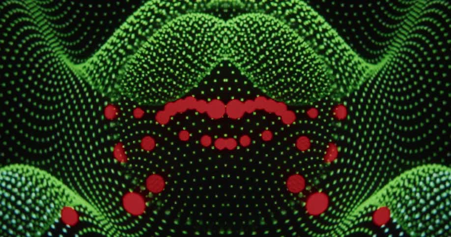 Hypnotic kaleidoscope of green digital waves and red dots manipulated by computer cursors on a black screen