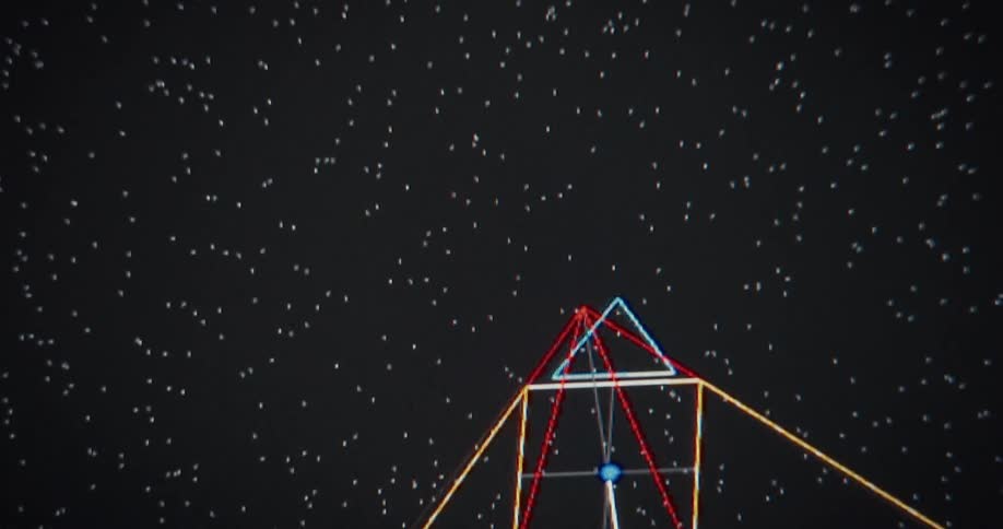 Flying through an abstract digital landscape of colorful wireframe pyramids and lines against a dark, starry background