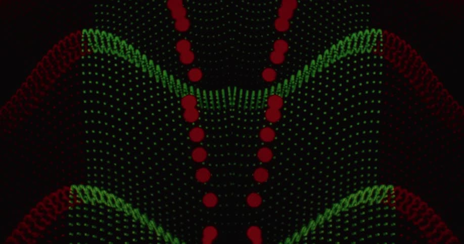 A hypnotic, symmetrical animation of red and green dot grids undulating in waves against a black background