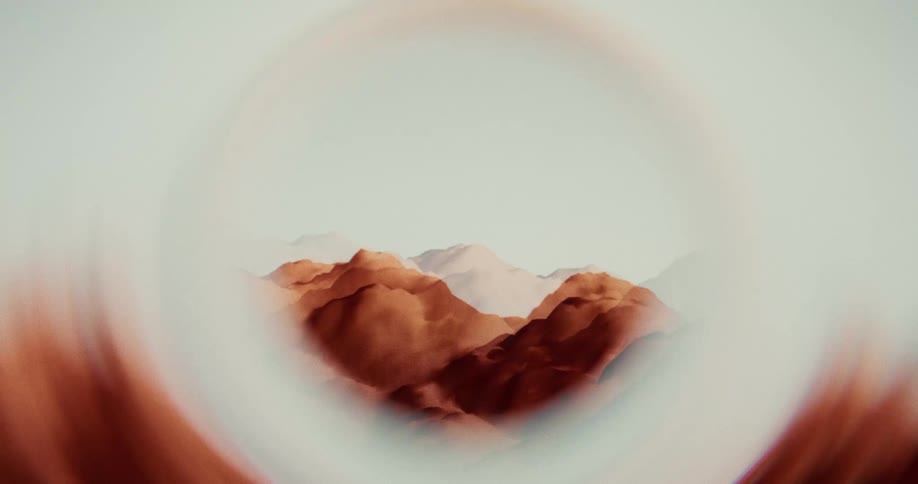 Surreal animated landscape of red mountains viewed through a distorted and glitching circular lens