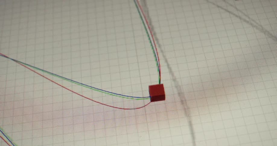 A designer manipulates anchor points and splines on a computer screen while working in a 3D animation program