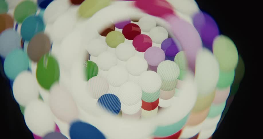 An abstract digital animation creates a psychedelic tunnel effect with swirling, colorful dots and shapes