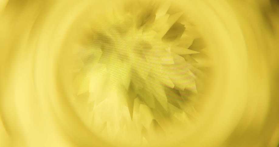 A fiery red abstract spiky circular animation with a radial blur slowly rotates and changes color to yellow before fading to white