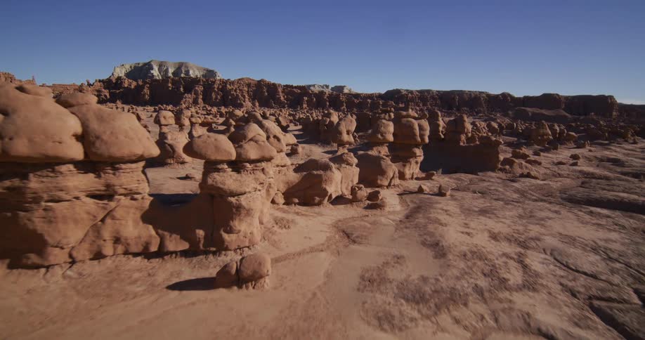 A slow aerial fly-through of the unique sandstone hoodoo rock formations in Goblin Valley, Utah