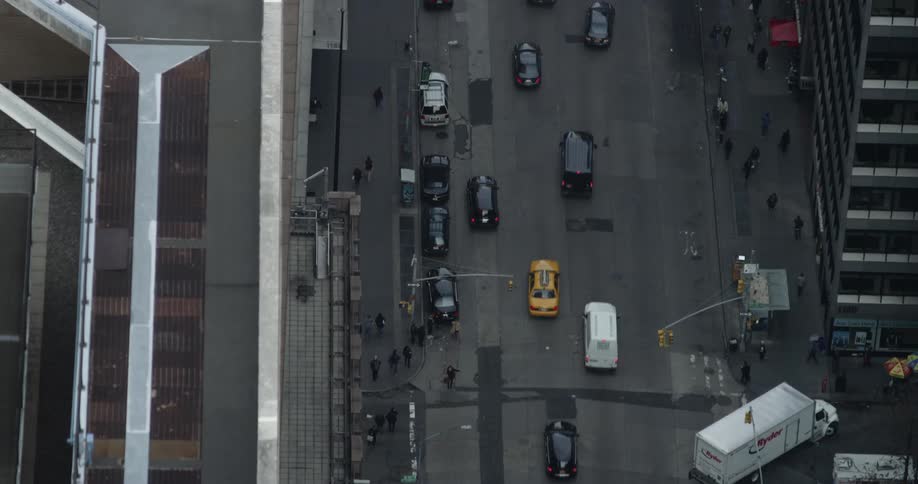 Aerial view of pedestrians and cars on a city street