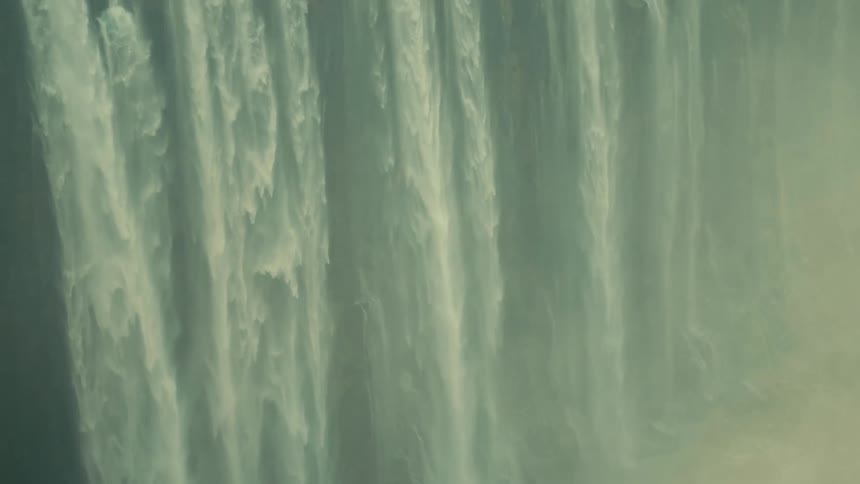 A mesmerizing close-up of a powerful, misty waterfall cascading in a seamless loop