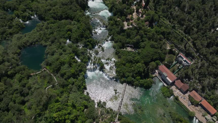 Static aerial top-down view of the stunning Skradinski Buk waterfalls and historic hydroelectric plant in Krka National Park, Croatia