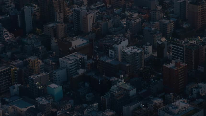 A static high-angle shot of a sprawling metropolitan city during the golden hour at dawn