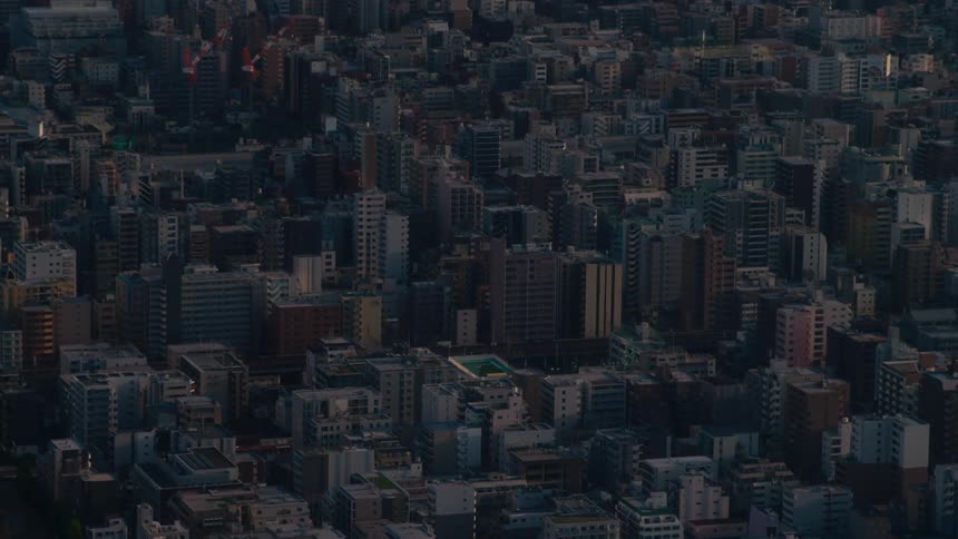 High-angle view of a vast and dense urban cityscape in Tokyo during the quiet moments of twilight