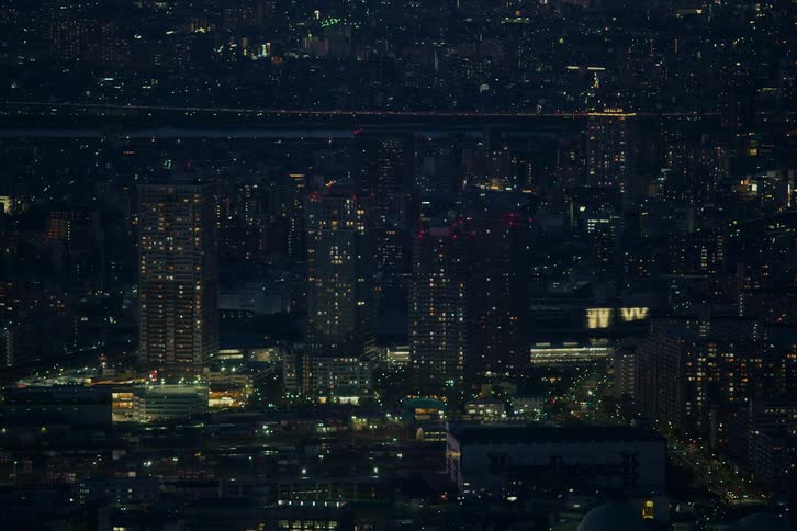 A sprawling cityscape glows with countless lights in a mesmerizing time-lapse as night falls over the metropolis