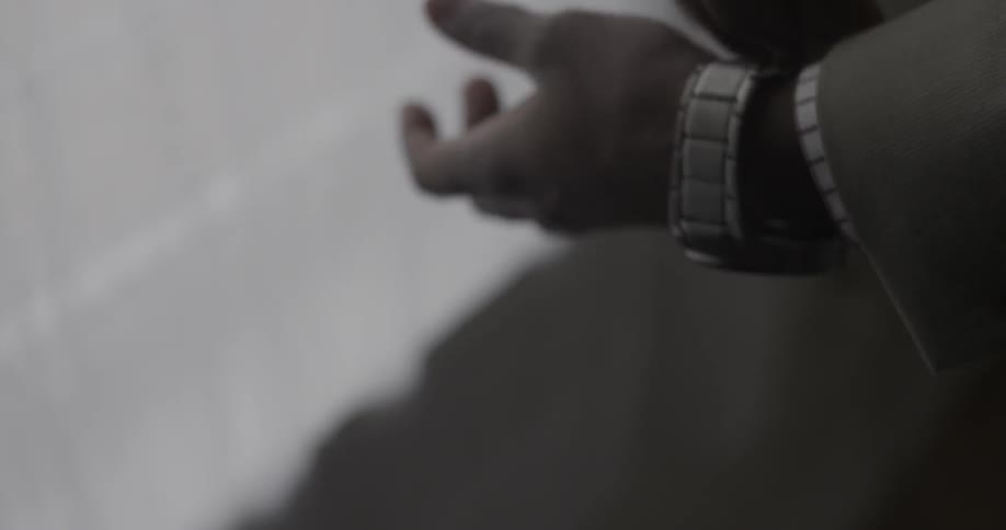 Person adjusts wristwatch and looks at it
