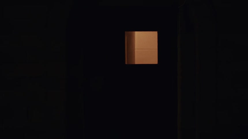 Exterior view of a building window at night with warm light coming from within