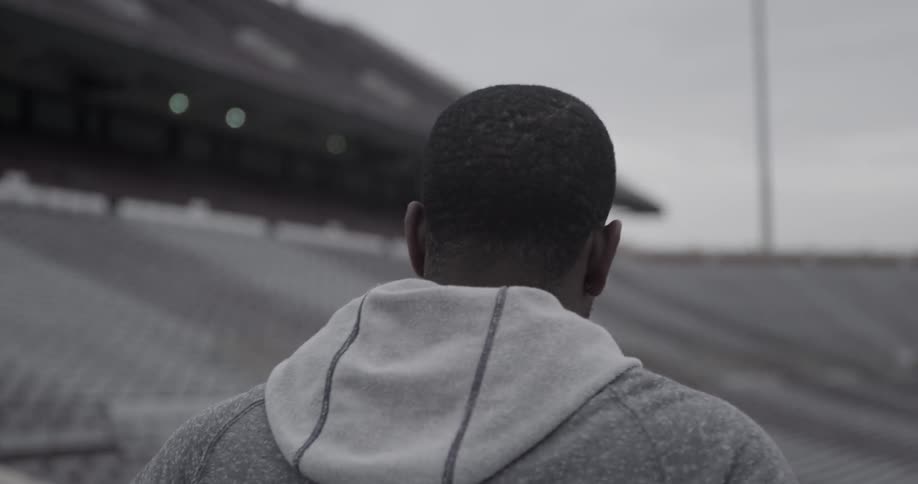 A male athlete looks around at a stadium