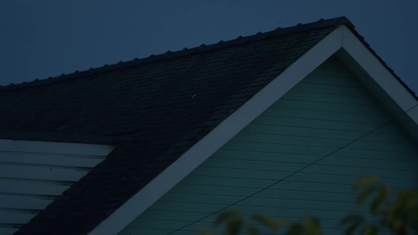 Close up of a roof of a house at night