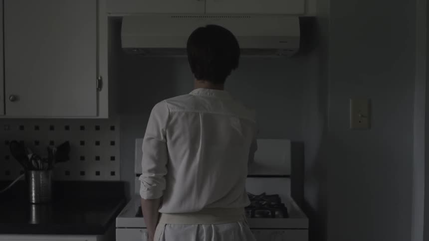 Woman cooking on a stove