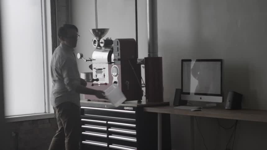 A man stands next to a piece of machinery