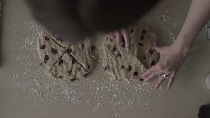 Person cuts raw cookie dough into wedges
