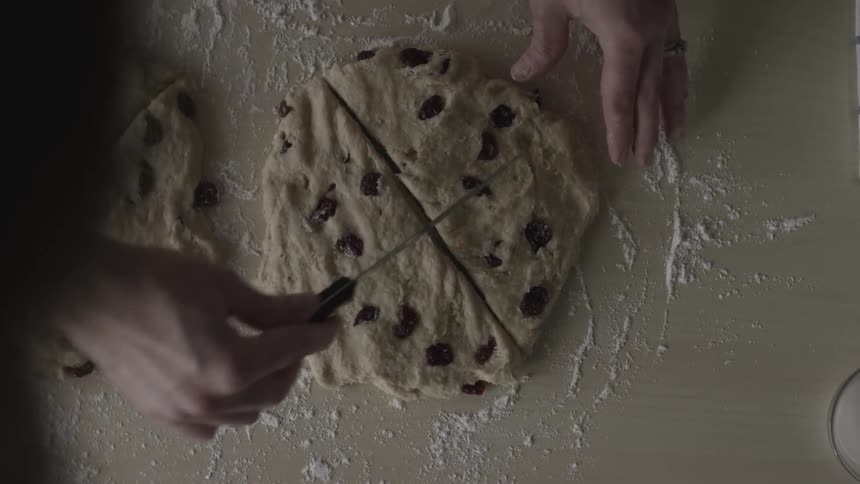 Person cuts raw cookie dough into wedges