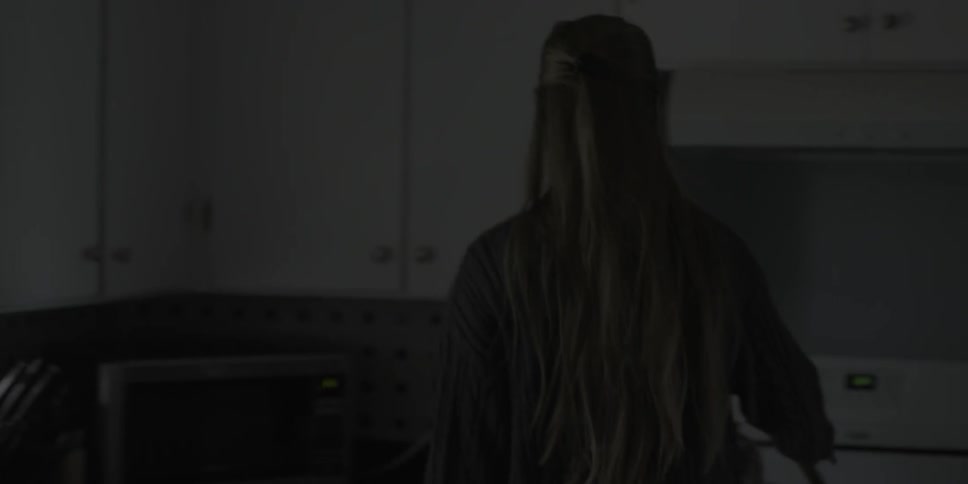 A woman goes to get a kettle to pour coffee