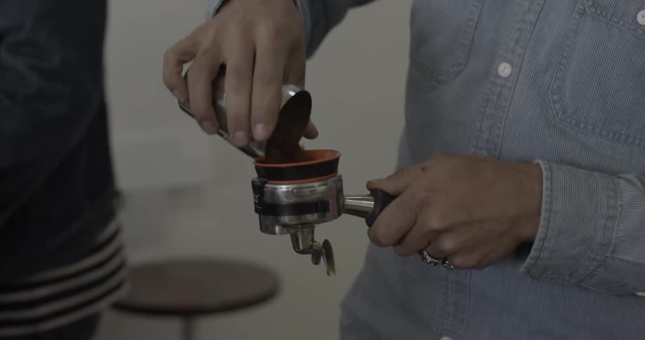 A man puts coffee into a filter