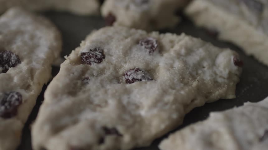 A person puts sugar on cookie dough