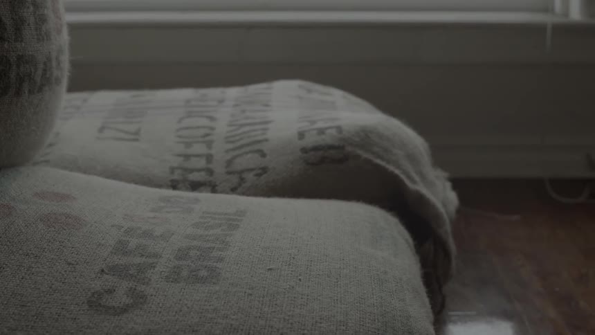 Bags of coffee are by the windowsill
