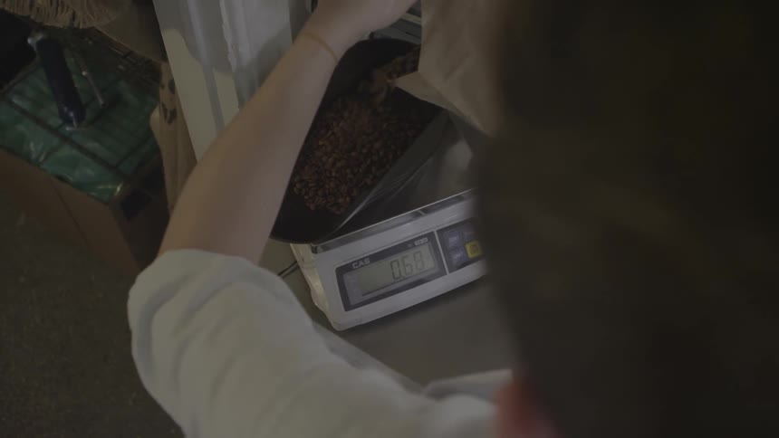 Coffee beans are weighed on a scale