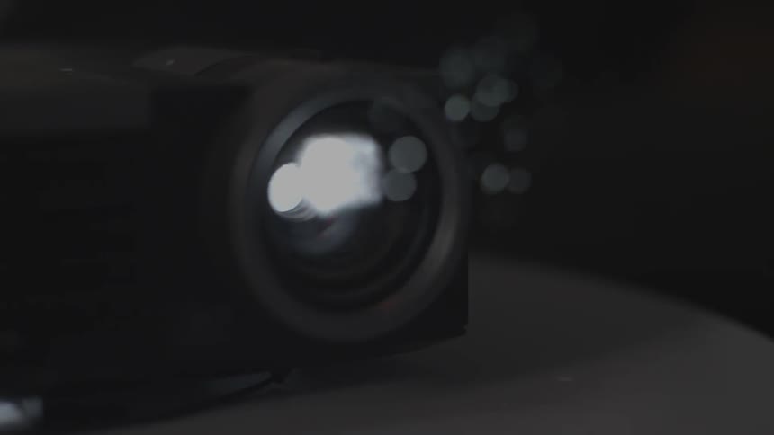 A projector sits on a table