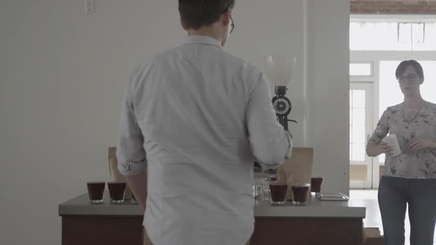 A man and woman serve up coffee drinks