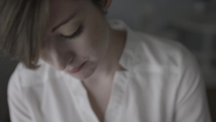 A woman is working on something looking down
