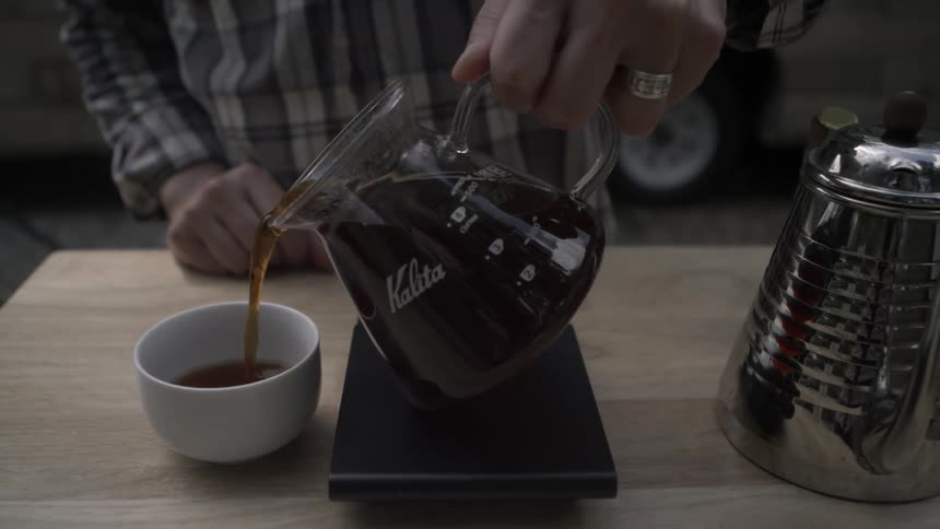 A man pours a cup of coffee