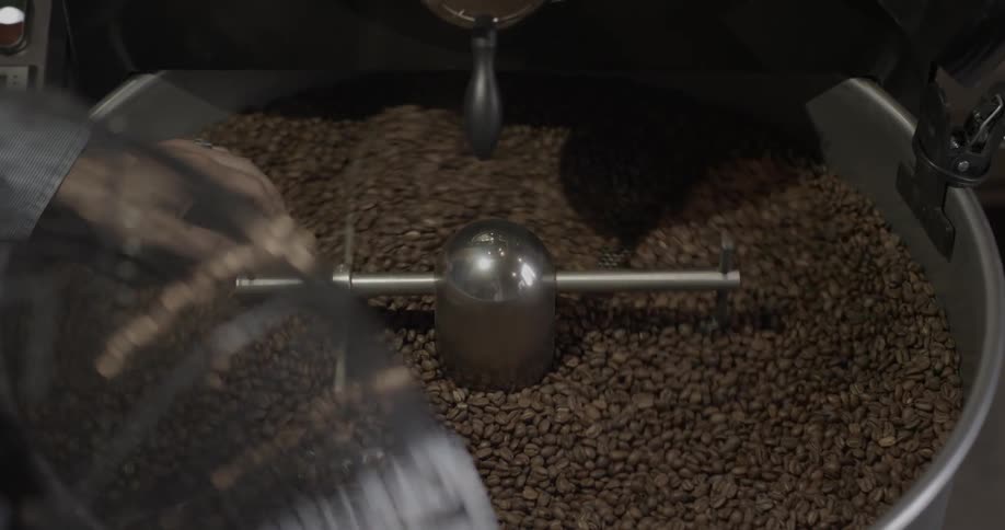 A machine is stirring coffee beans