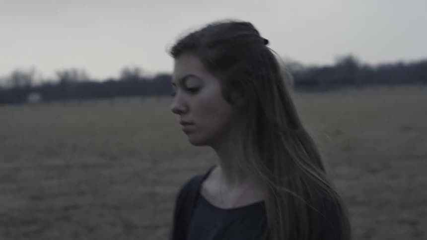 Woman walks in a large field