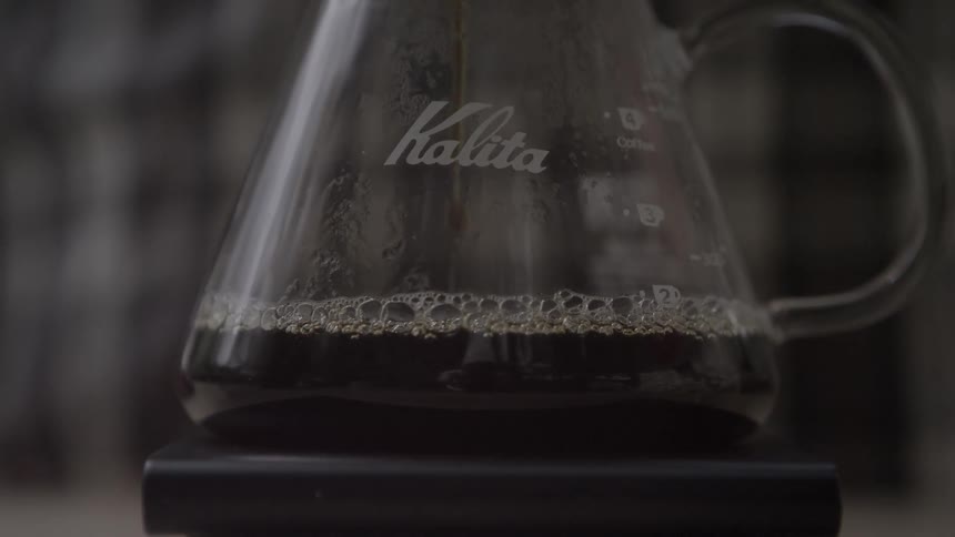 Coffee drips into a glass carafe