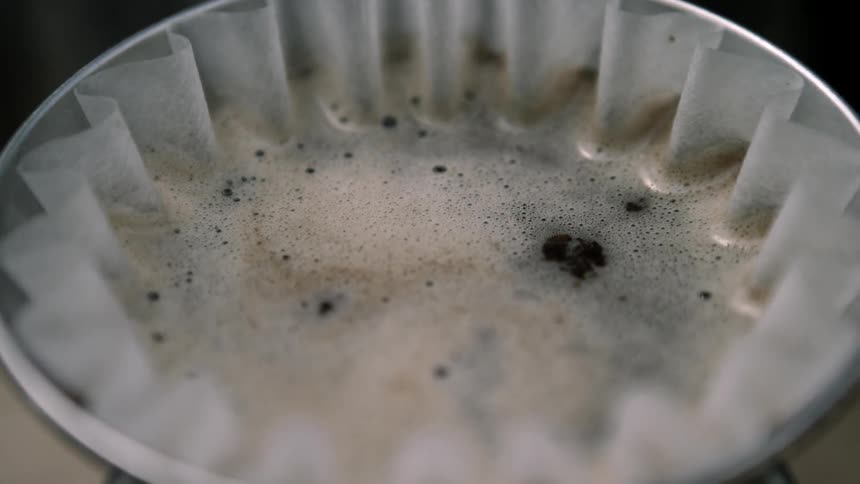 Foamy coffee sits in a coffee filter
