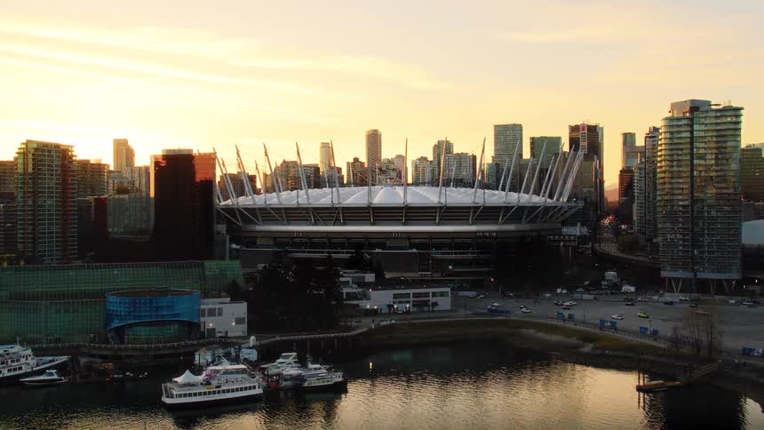 Stunning aerial shot of BC Place Stadium and the Vancouver cityscape glowing in the warm light of sunset