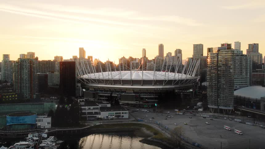 A beautiful aerial shot of BC Place stadium as the sun sets over the Vancouver skyline