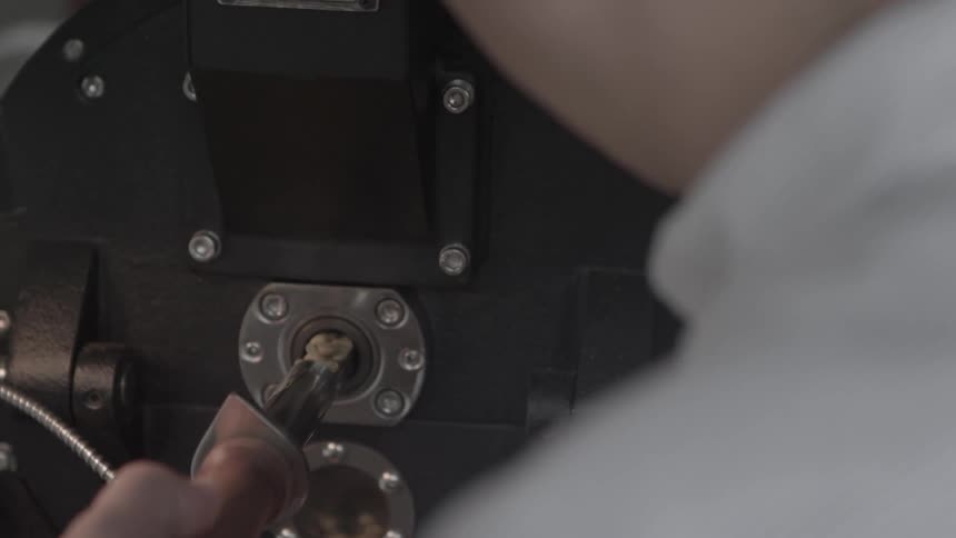 Person pulls piece out of machine and puts it back in