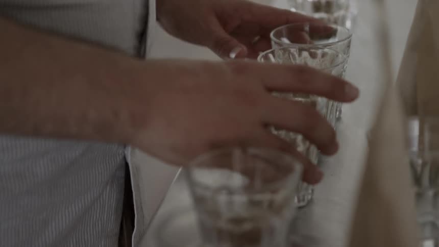 A man taste tests a row of beverages