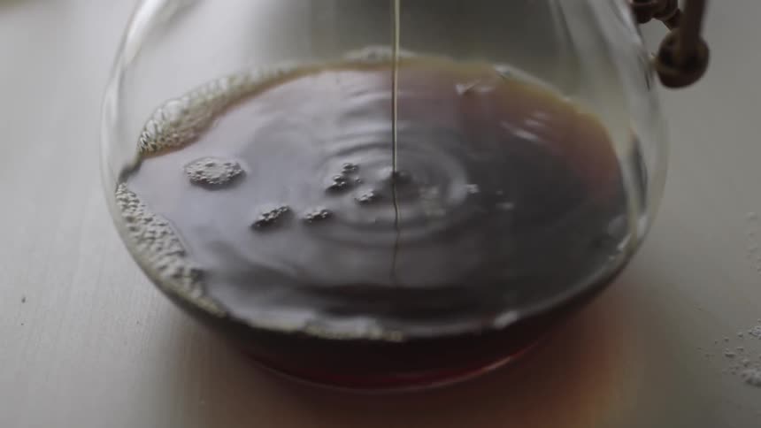 Coffee drips into a glass carafe