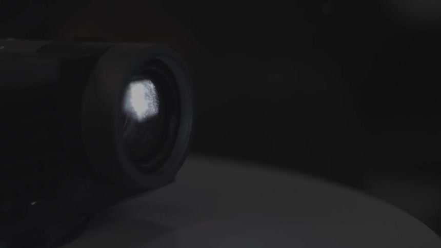 Dust floats around in front of a projector light