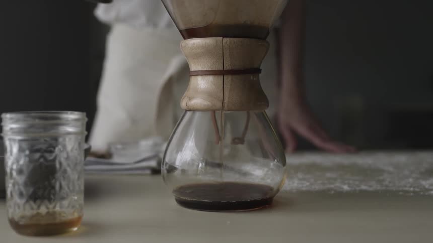 Coffee drips into a glass carafe