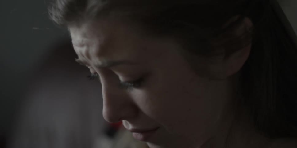 Close up of woman's sad face as she drinks out of a mug