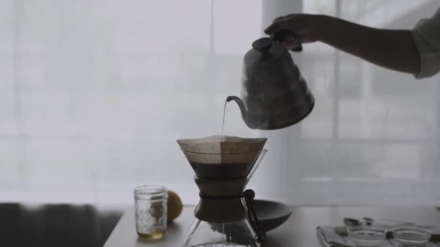 Steaming water is poured into a coffee filter