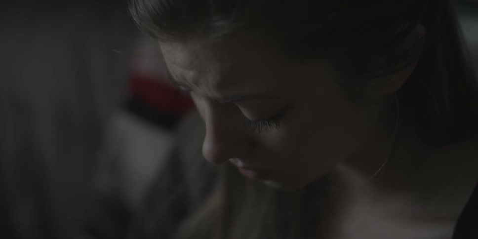 A woman looks sad as she drinks from a mug